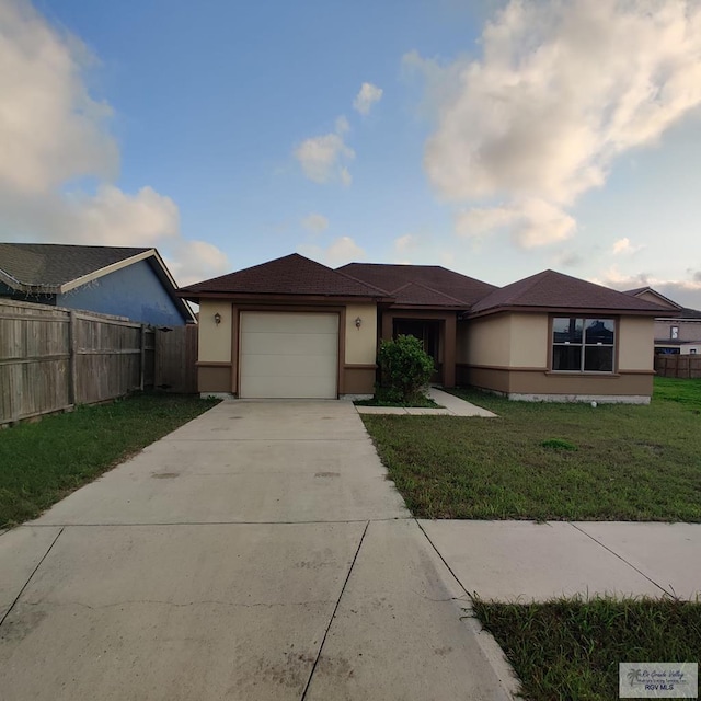 view of front facade featuring a garage and a front lawn