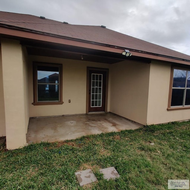 back of property with a patio