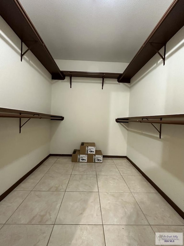 spacious closet featuring light tile patterned flooring