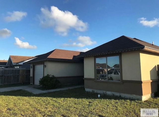 view of side of property with a lawn