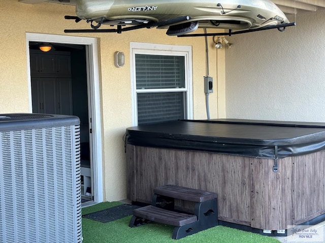 view of patio featuring central AC unit and a hot tub