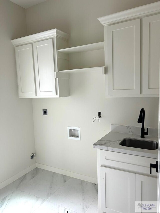 washroom featuring hookup for a washing machine, cabinets, hookup for an electric dryer, and sink