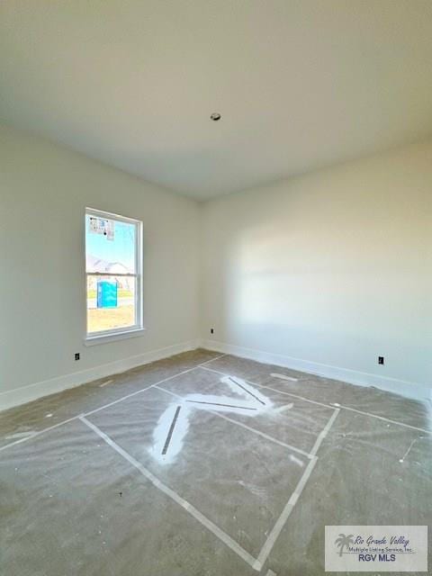 interior space with unfinished concrete flooring and baseboards