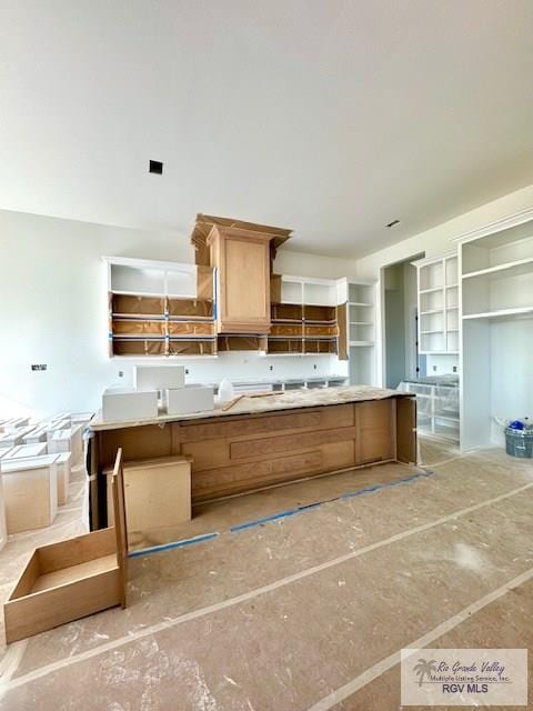 kitchen with open shelves, light countertops, and light brown cabinetry