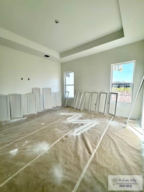 spare room with a tray ceiling and visible vents