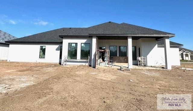 back of property with stucco siding