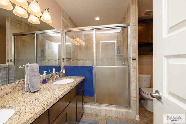 23314 Grapefruit Ave, Harlingen, TX 78552 - full bath featuring double vanity, a shower stall, recessed lighting, and tile patterned floors
