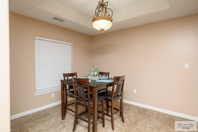 23314 Grapefruit Ave, Harlingen, TX 78552 - dining space with a tray ceiling and baseboards