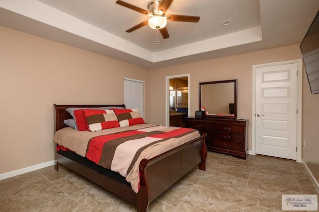 23314 Grapefruit Ave, Harlingen, TX 78552 - bedroom featuring a tray ceiling, a ceiling fan, and ensuite bathroom