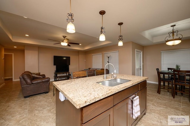 23314 Grapefruit Ave, Harlingen, TX 78552 - kitchen with a tray ceiling, pendant lighting, open floor plan, and recessed lighting