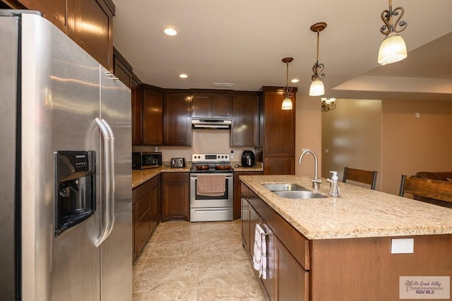 23314 Grapefruit Ave, Harlingen, TX 78552 - kitchen with appliances with stainless steel finishes, under cabinet range hood, recessed lighting, an island with sink, and pendant lighting