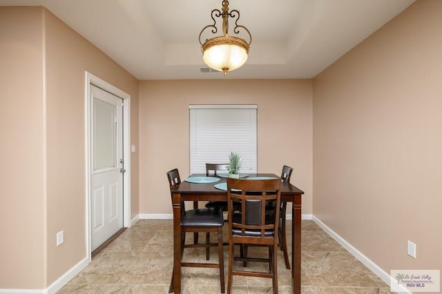 23314 Grapefruit Ave, Harlingen, TX 78552 - dining area featuring a raised ceiling and baseboards
