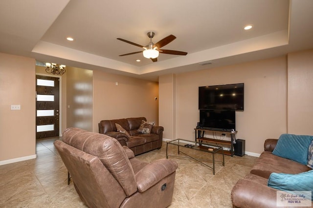 23314 Grapefruit Ave, Harlingen, TX 78552 - living area with a tray ceiling, recessed lighting, a chandelier, ceiling fan, and light tile patterned floors