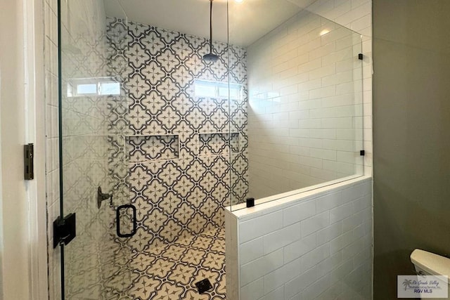 bathroom featuring a shower with door