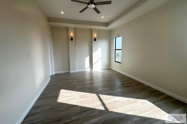 unfurnished room featuring ceiling fan and dark wood-type flooring