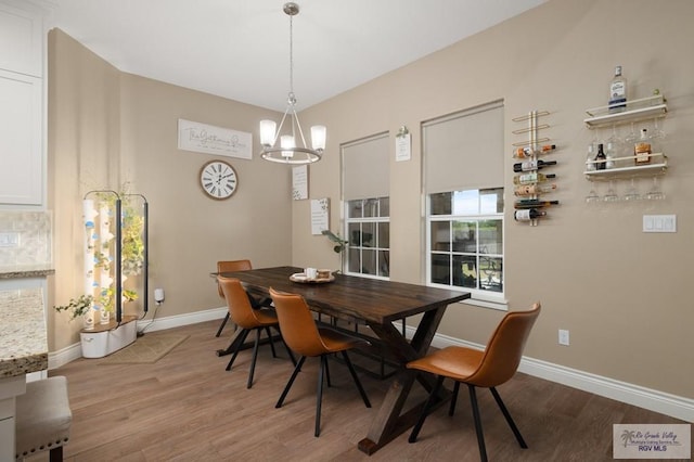 16620 W Duff Ct, Harlingen, TX 78552 - dining area featuring wood finished floors and a chandelier
