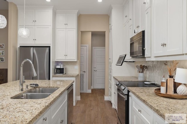 16620 W Duff Ct, Harlingen, TX 78552 - kitchen with appliances with stainless steel finishes, light wood-style flooring, white cabinets, recessed lighting, and decorative backsplash