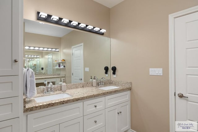 16620 W Duff Ct, Harlingen, TX 78552 - bathroom with double vanity and baseboards