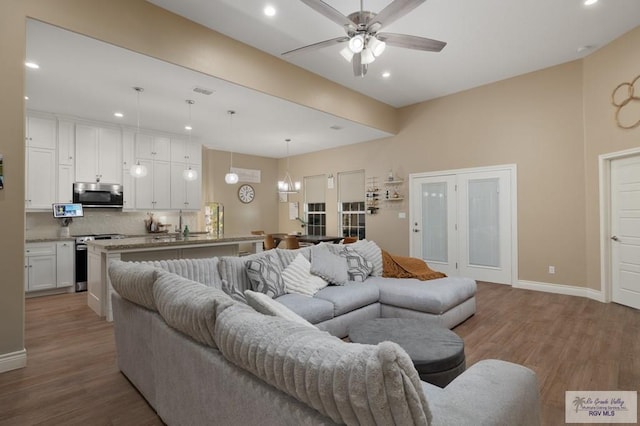 16620 W Duff Ct, Harlingen, TX 78552 - living room with light wood-type flooring, recessed lighting, and ceiling fan