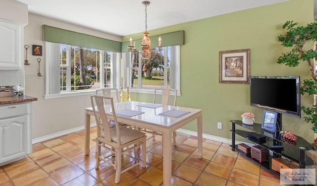 dining room featuring light tile patterned floors and baseboards