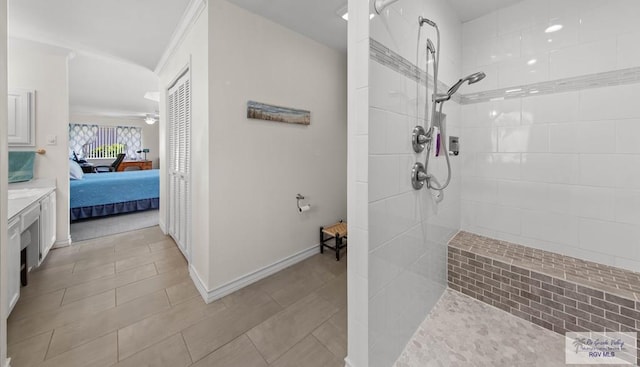 ensuite bathroom featuring a ceiling fan, a walk in shower, baseboards, and connected bathroom