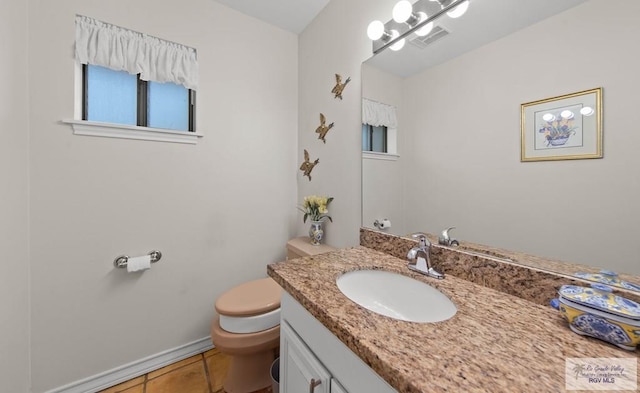 bathroom with visible vents, toilet, vanity, and tile patterned flooring