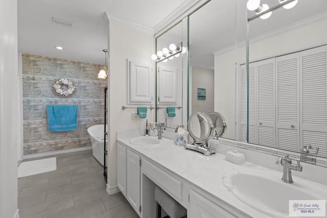 bathroom with crown molding, wallpapered walls, an accent wall, and a sink