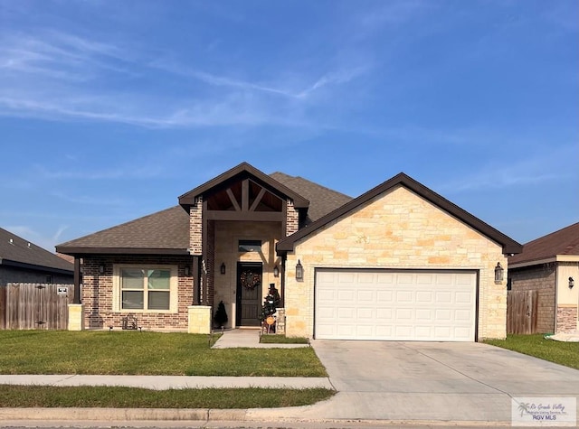 view of front of home featuring a front yard and a garage