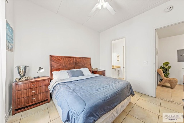 tiled bedroom with ensuite bathroom, ceiling fan, and electric panel