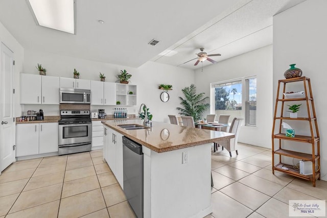 kitchen featuring white cabinetry, sink, an island with sink, and appliances with stainless steel finishes