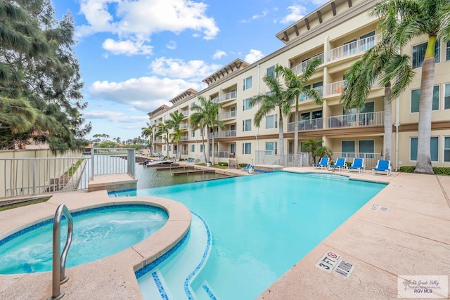 view of swimming pool featuring a community hot tub