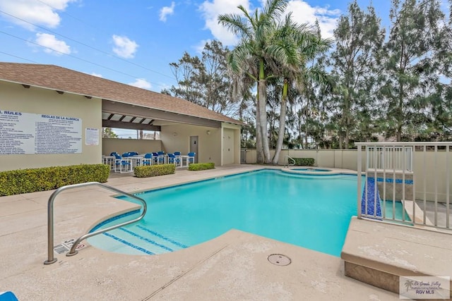 view of pool featuring a community hot tub and a patio