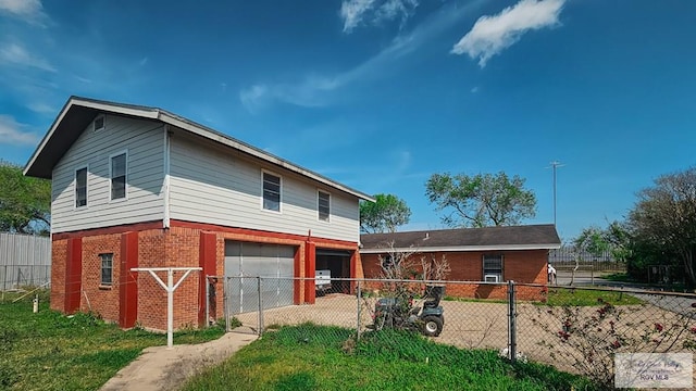 rear view of house with a garage and a yard