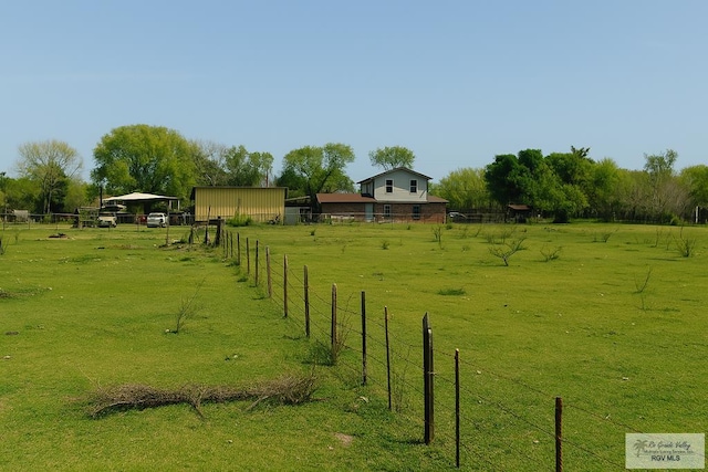 4425 S Oklahoma Ave, Brownsville, TX 78520 - view of yard with fence, a pole building, a rural view, a detached carport, and an outdoor structure
