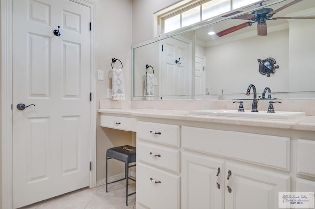 bathroom with crown molding, tile patterned flooring, and vanity