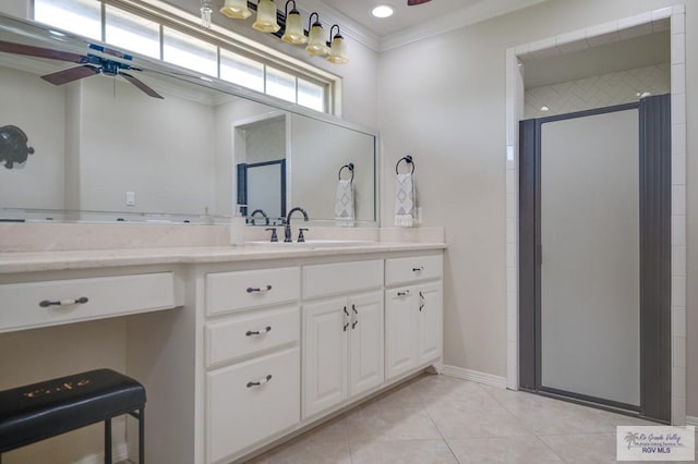 bathroom with ornamental molding, vanity, ceiling fan, tile patterned flooring, and a shower with shower door