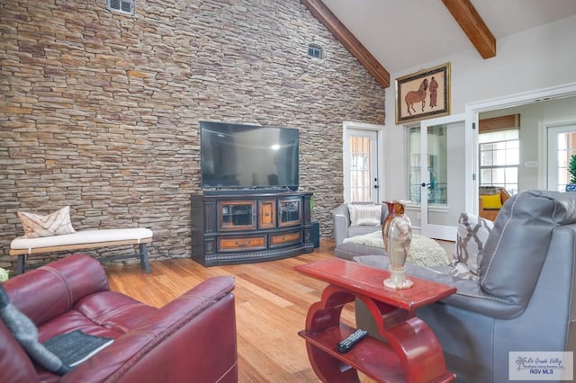 living room with beamed ceiling, french doors, high vaulted ceiling, and wood-type flooring