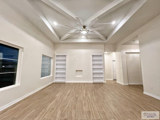 unfurnished living room with baseboards, a ceiling fan, and wood finished floors