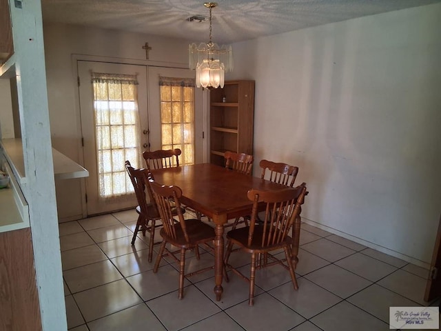535 Windwood Way, Brownsville, TX 78526 - dining space featuring a chandelier and light tile patterned floors