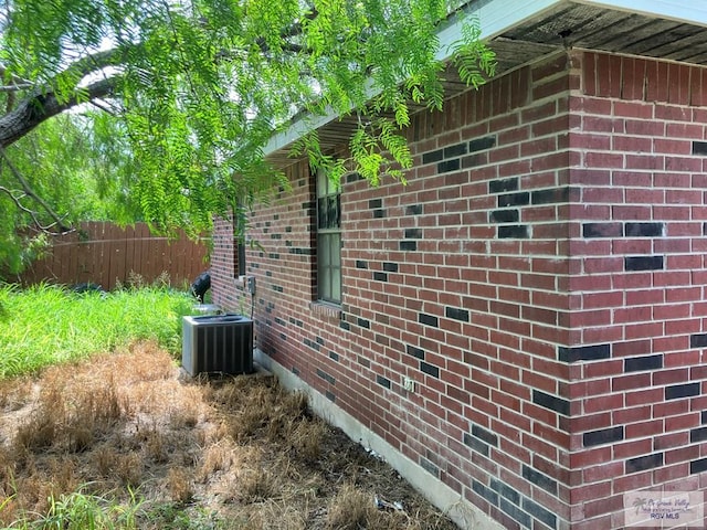 535 Windwood Way, Brownsville, TX 78526 - view of property exterior with a central air condition unit and brick siding