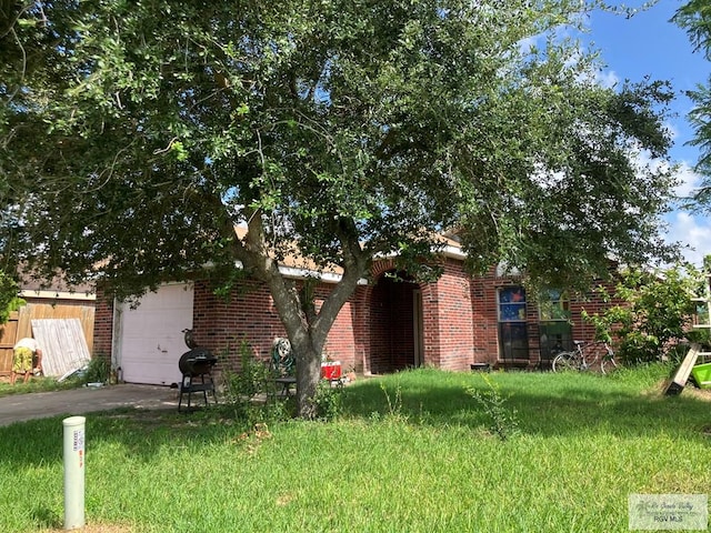 535 Windwood Way, Brownsville, TX 78526 - view of front of home with asphalt driveway, a garage, and brick siding