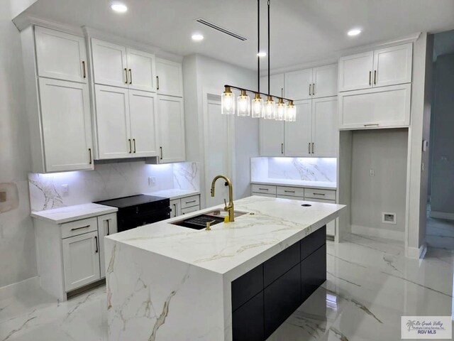 115 Finch Dr, Los Fresnos, TX 78566 - kitchen featuring light marble finish floors, white cabinetry, tasteful backsplash, recessed lighting, and light stone countertops