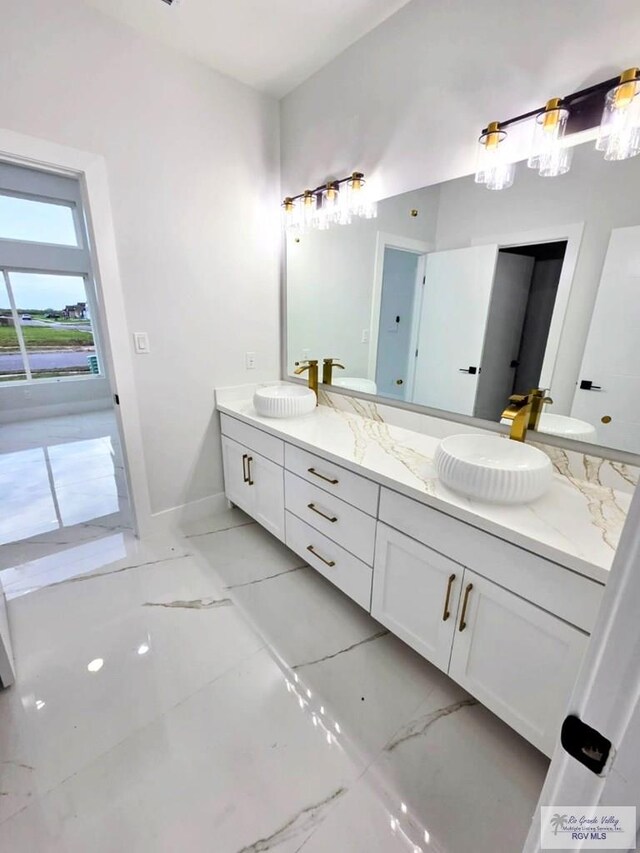115 Finch Dr, Los Fresnos, TX 78566 - bathroom with double vanity and baseboards