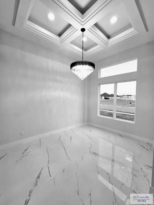 115 Finch Dr, Los Fresnos, TX 78566 - empty room with a chandelier, marble finish floors, and beamed ceiling