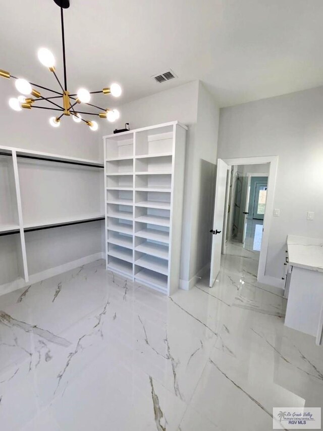 115 Finch Dr, Los Fresnos, TX 78566 - unfurnished bedroom featuring a chandelier and light marble finish flooring