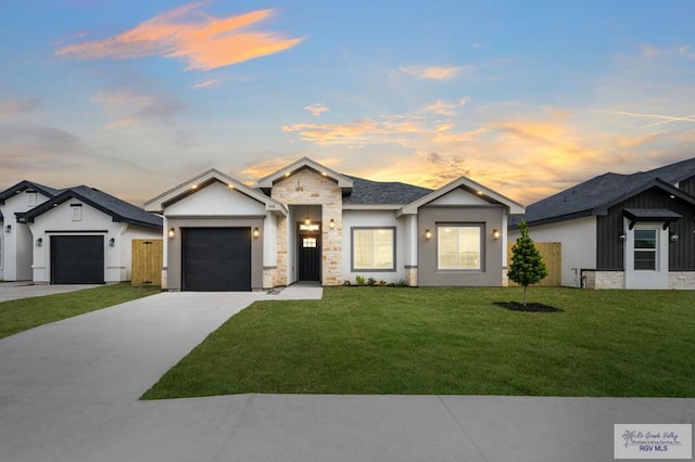 view of front facade with a yard and a garage