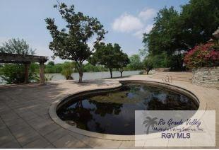 view of pool with a water view, a pergola, and a patio