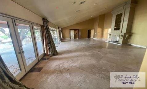 interior space featuring french doors and vaulted ceiling