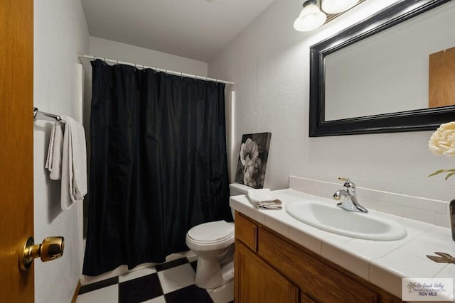 1675 Chipinque Dr, Brownsville, TX 78526 - bathroom featuring tile patterned floors, toilet, vanity, and curtained shower