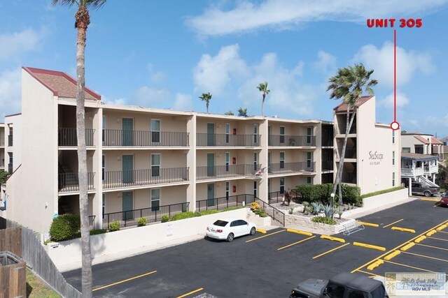 116 E Polaris Dr Unit 305, South Padre Island, TX 78597 - view of apartment building / complex featuring uncovered parking